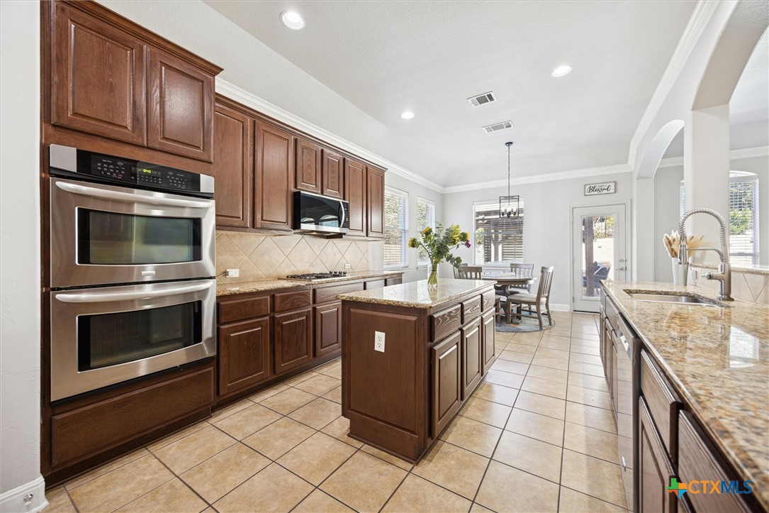 2309 First View Leander, TX 78641 - Photo 17 of 31 A spacious island anchors the kitchen while built-in double ovens and extensive cabinetry add both style and functionality.