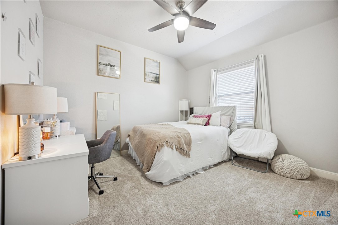 2309 First View Leander, TX 78641 - Photo 21 of 31 A cozy secondary bedroom with soft natural light, neutral tones, and comfortable space for guests or family.