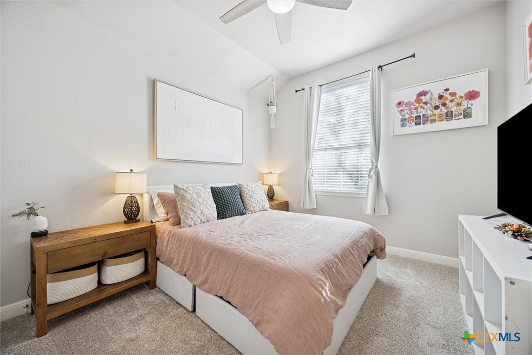 2309 First View Leander, TX 78641 - Photo 22 of 31 Vaulted ceilings and a bright window give this bedroom an airy feel while maintaining a warm, relaxing atmosphere.