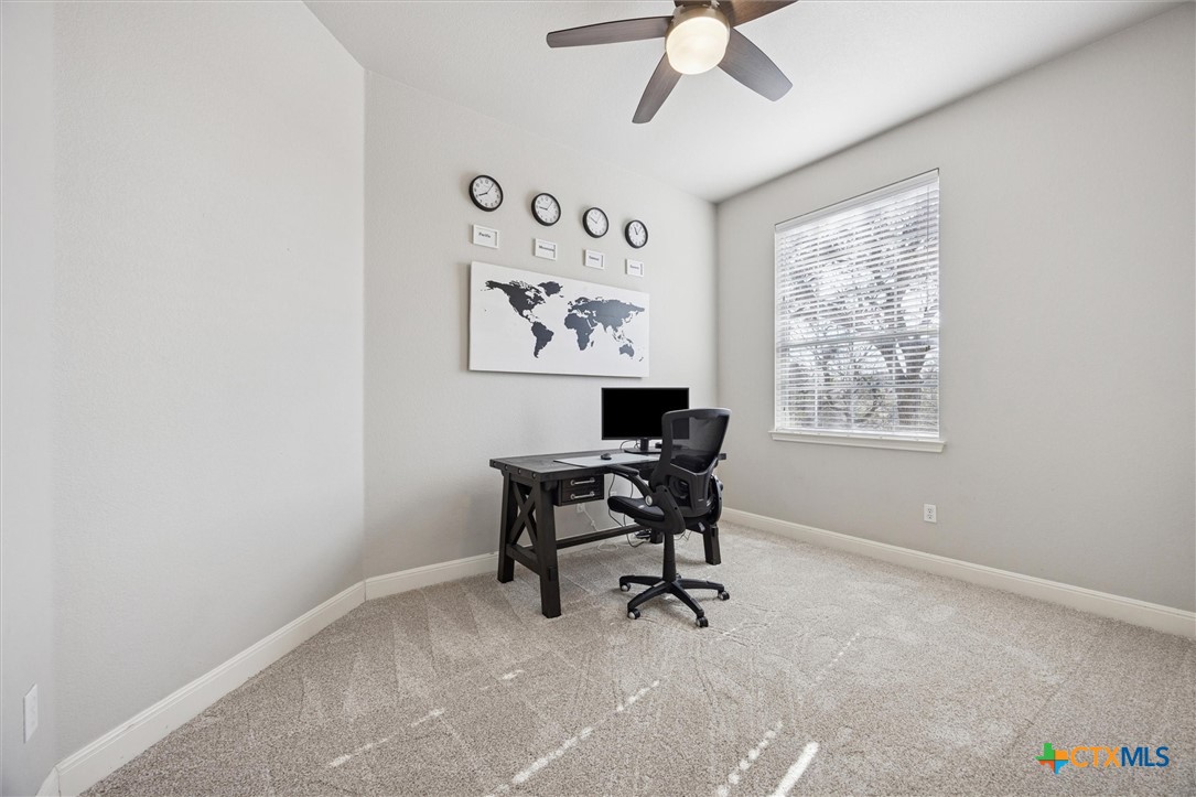 2309 First View Leander, TX 78641 - Photo 4 of 31 A bright and versatile room with soft carpeting, a large window for natural light, and high ceilings that create an open and comfortable workspace.