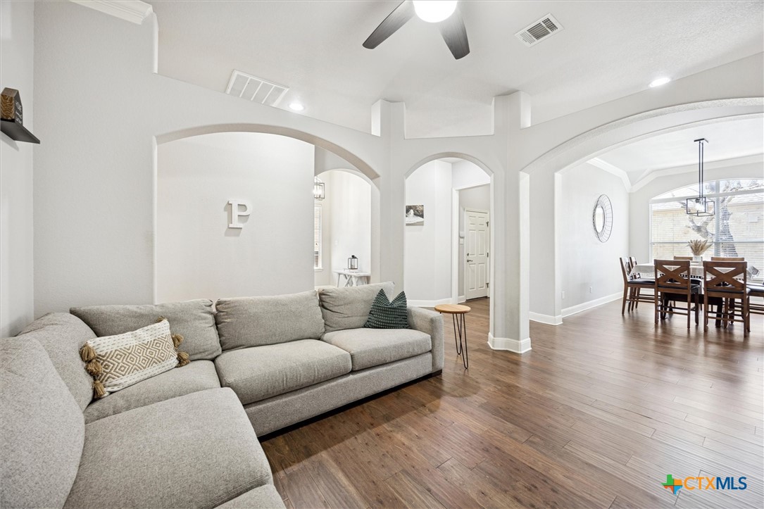 2309 First View Leander, TX 78641 - Photo 10 of 31 Arched openings and soaring ceilings lead into the formal living area, where the layout encourages an easy flow throughout the home.