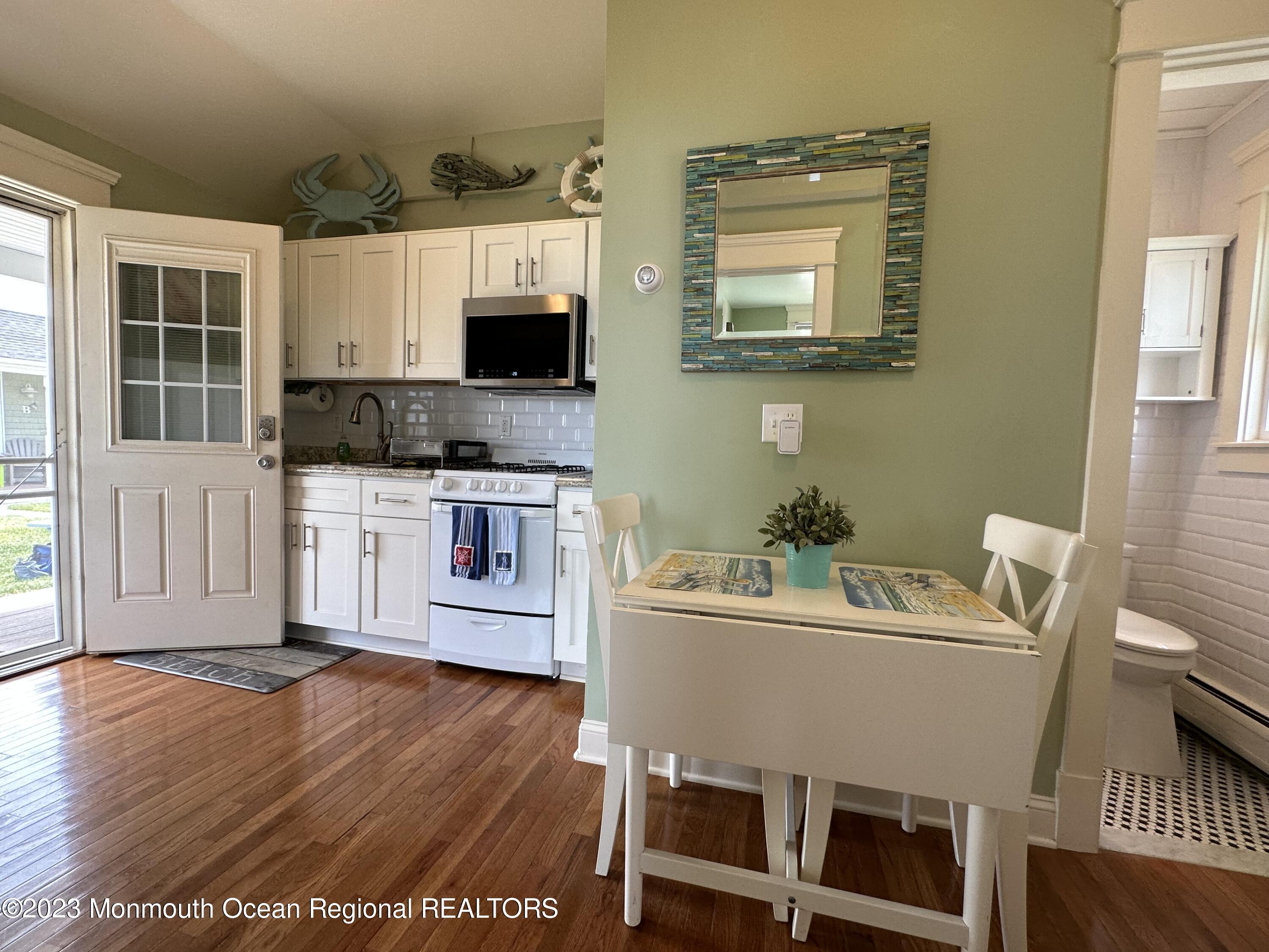 58 5th Street, Unit F Highlands, NJ 07732 - Photo 11 of 33 a living room with a couch and a wooden floor