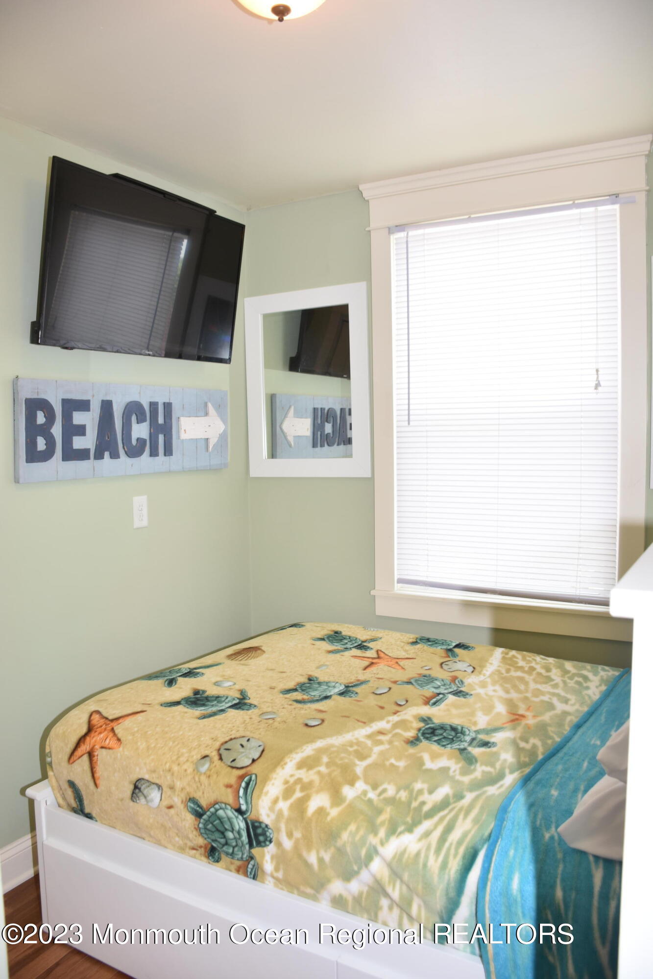 58 5th Street, Unit F Highlands, NJ 07732 - Photo 18 of 33 a bedroom with a bed and flat screen tv