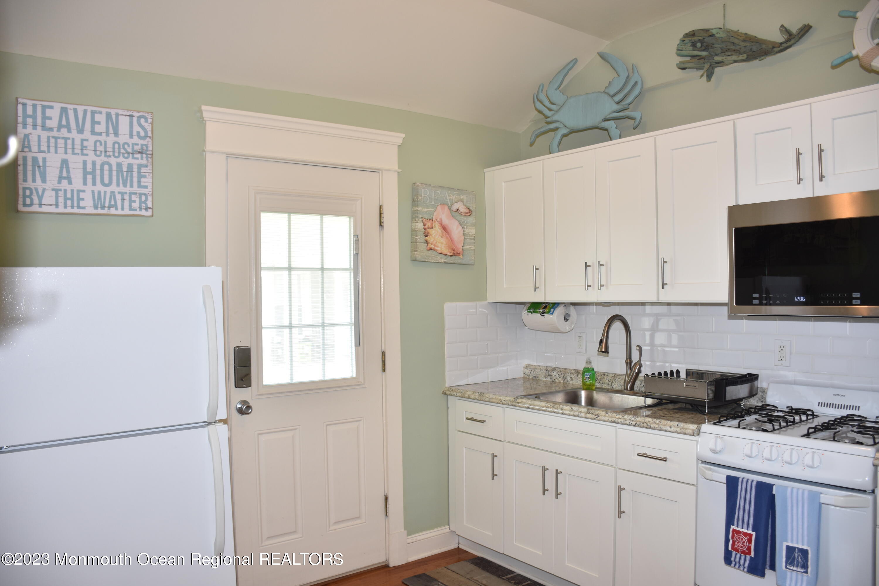 58 5th Street, Unit F Highlands, NJ 07732 - Photo 10 of 33 a kitchen with a sink a stove and cabinets