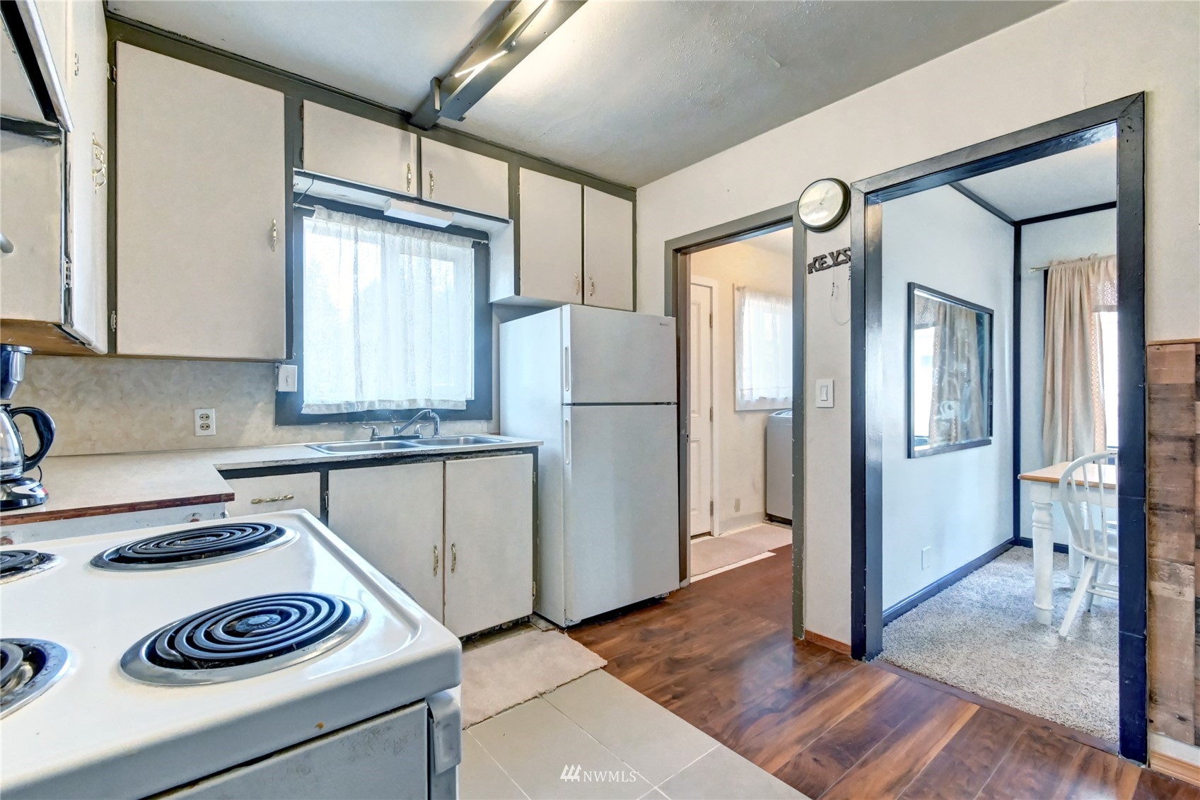 6932 Carson Road Everett, WA 98203 - Photo 11 of 24 a kitchen with a refrigerator and a stove top oven