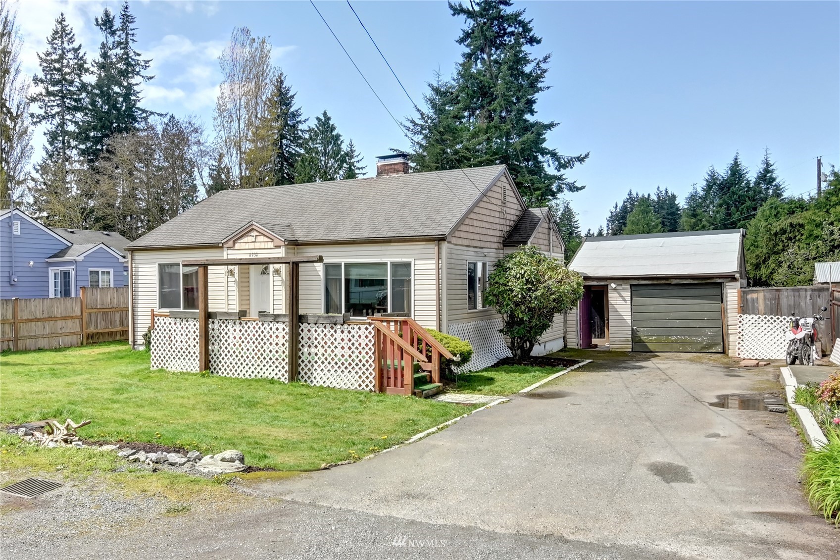 6932 Carson Road Everett, WA 98203 - Photo 2 of 24 a front view of a house with a garden and yard