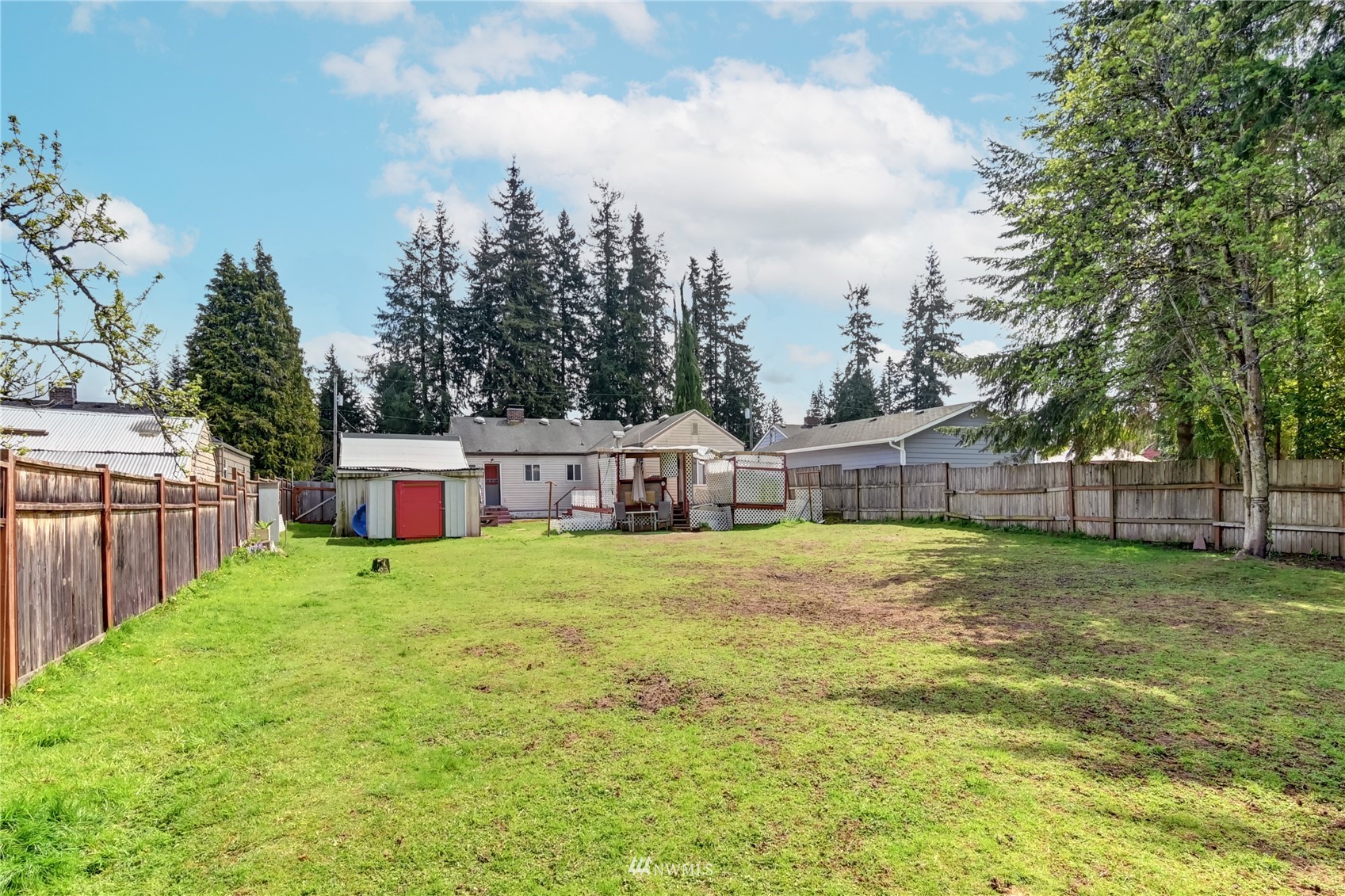 6932 Carson Road Everett, WA 98203 - Photo 23 of 24 a house that is sitting in the grass with tress in the background