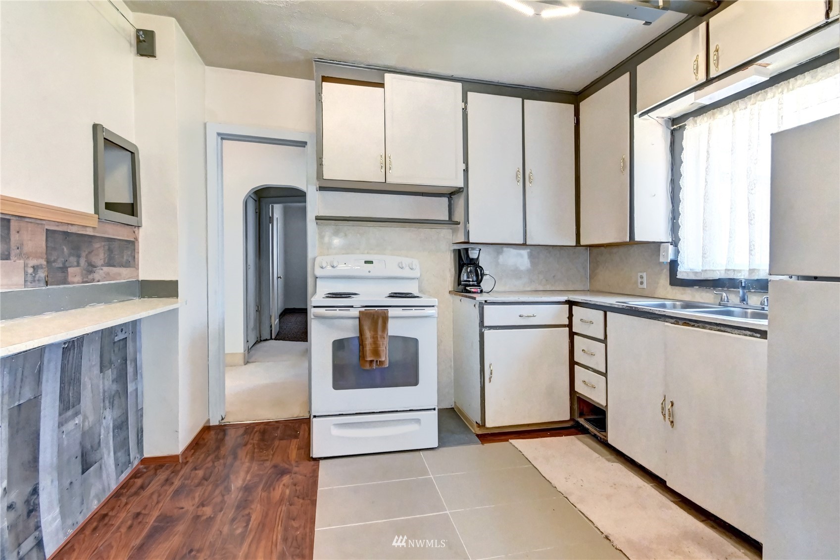 6932 Carson Road Everett, WA 98203 - Photo 8 of 24 a kitchen with stainless steel appliances granite countertop a stove a sink and a refrigerator