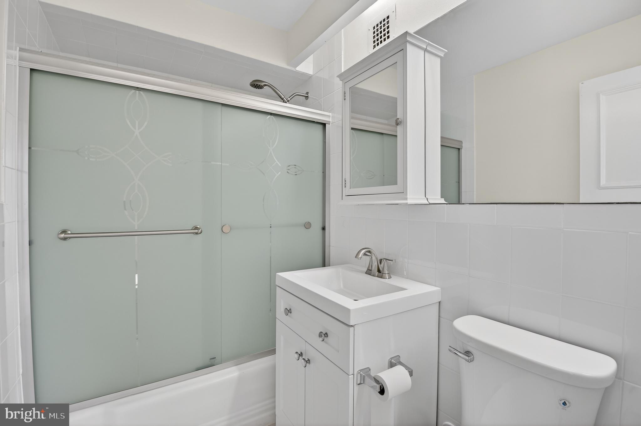 4000 Tunlaw Road Northwest, Unit 415 Washington, DC 20007 - Photo 14 of 28 a bathroom with a sink a toilet and shower
