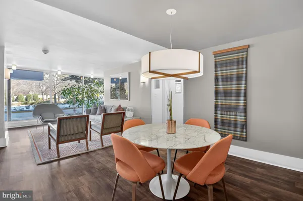 a outdoor dining room with furniture a rug and wooden floor