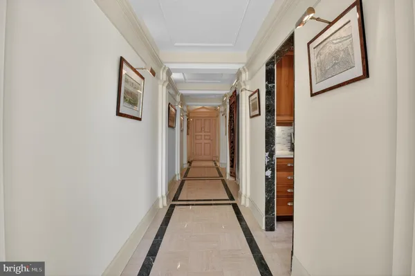 a view of a hallway with wooden floor and stairs