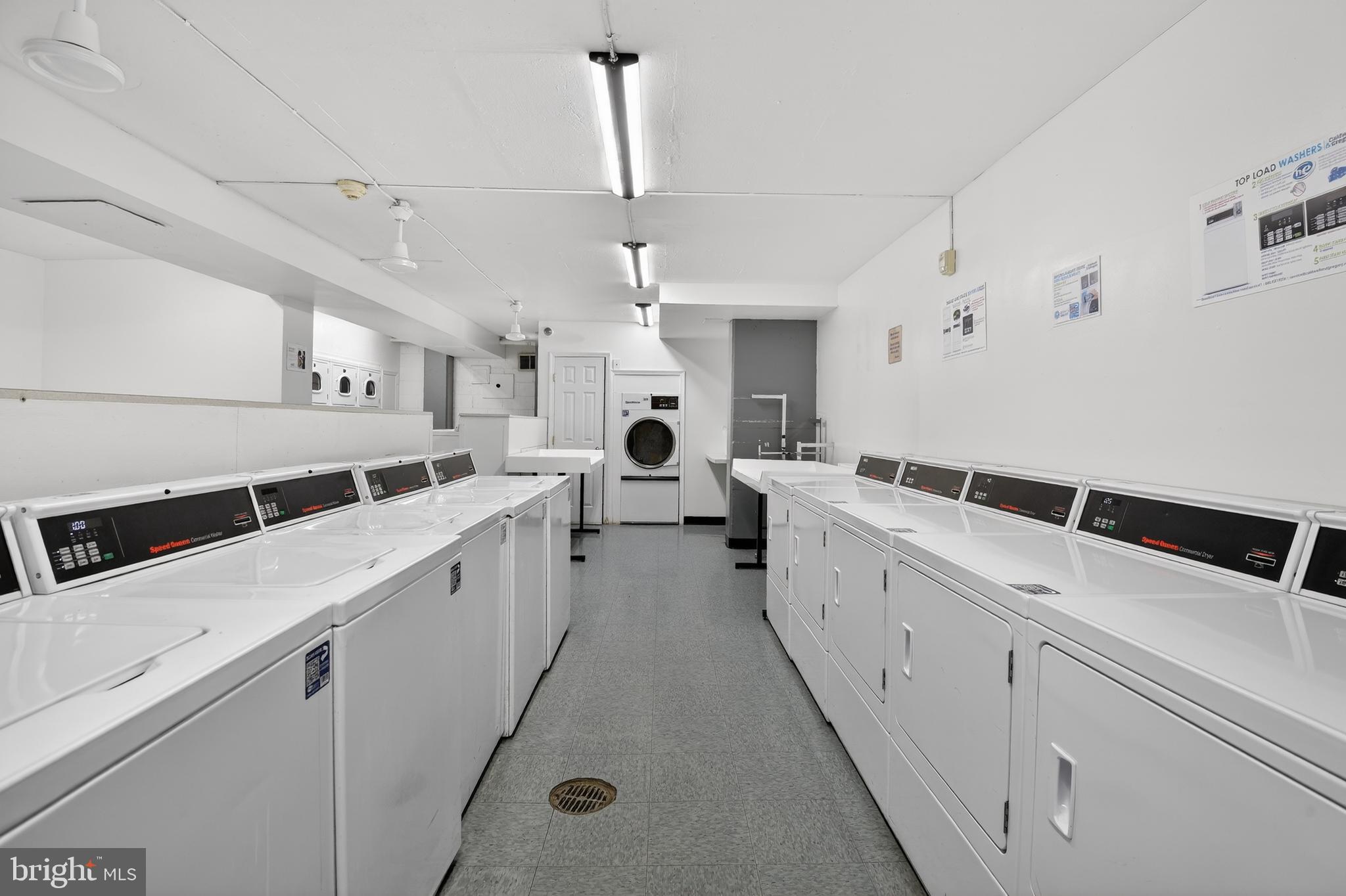 4000 Tunlaw Road Northwest, Unit 415 Washington, DC 20007 - Photo 21 of 28 a large white kitchen with sink and white cabinets