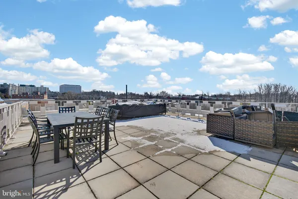 a view of a terrace with furniture and city view