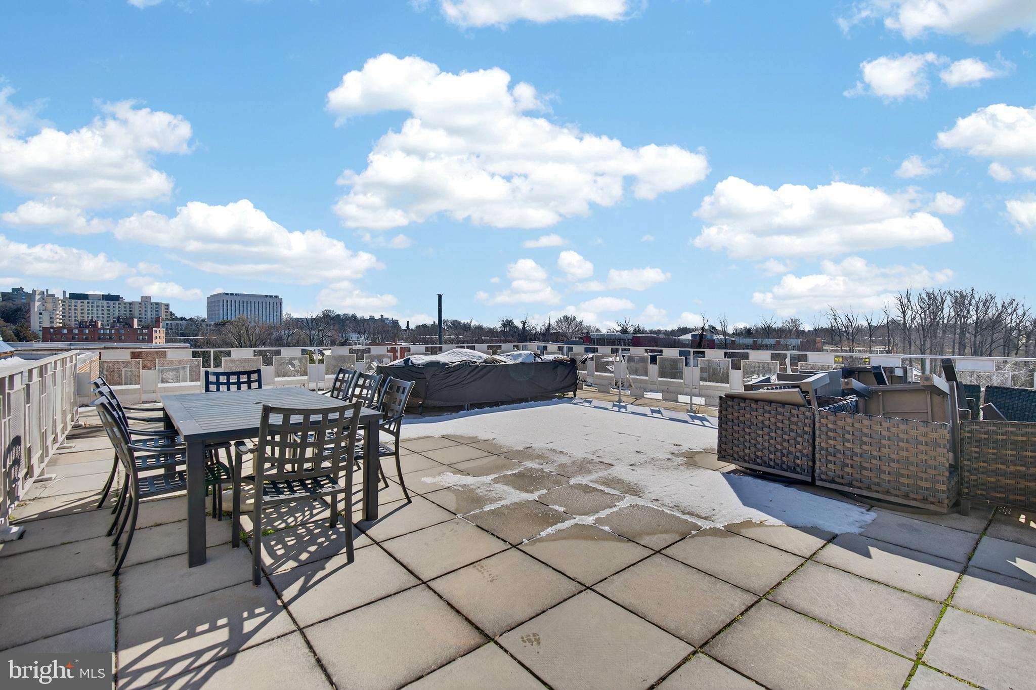 4000 Tunlaw Road Northwest, Unit 415 Washington, DC 20007 - Photo 23 of 28 a view of a terrace with furniture and city view