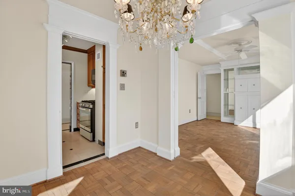 a view of a hallway view with chandelier