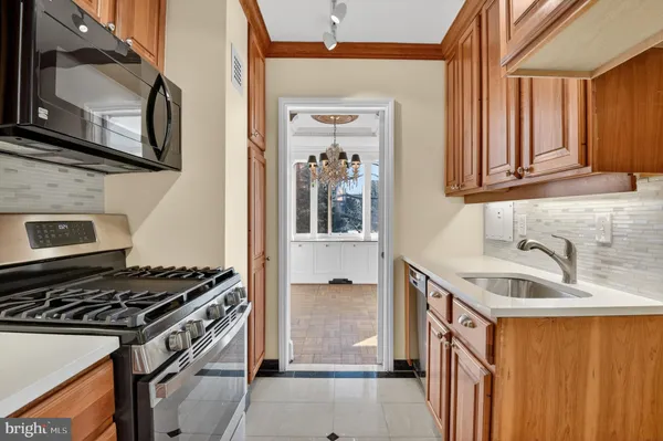 a kitchen that has a sink and a stove