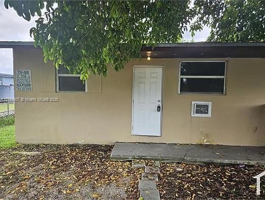 26625 Southwest 139th Avenue, Unit 26625 Homestead, FL 33032 - Photo 1 of 6 a front view of a house with a yard