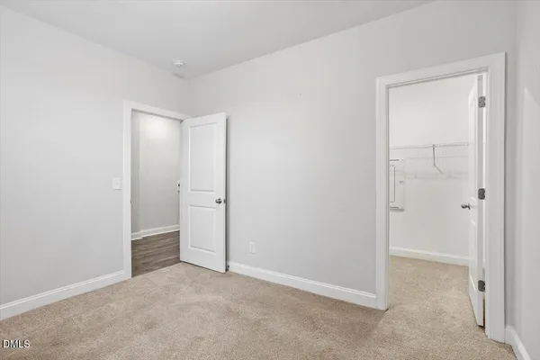an empty room with closet area