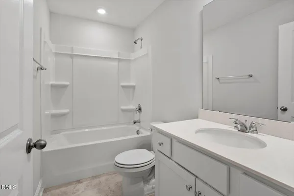 a bathroom with a sink toilet vanity and shower