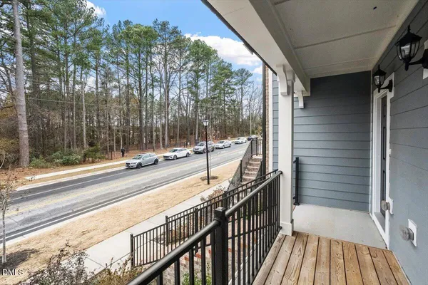 a view of balcony with wooden floor and fence