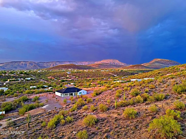 a view of a large mountain with mountains in the background