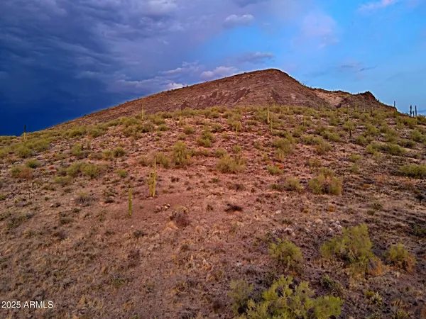 a view of a mountain range in a cloudy sky