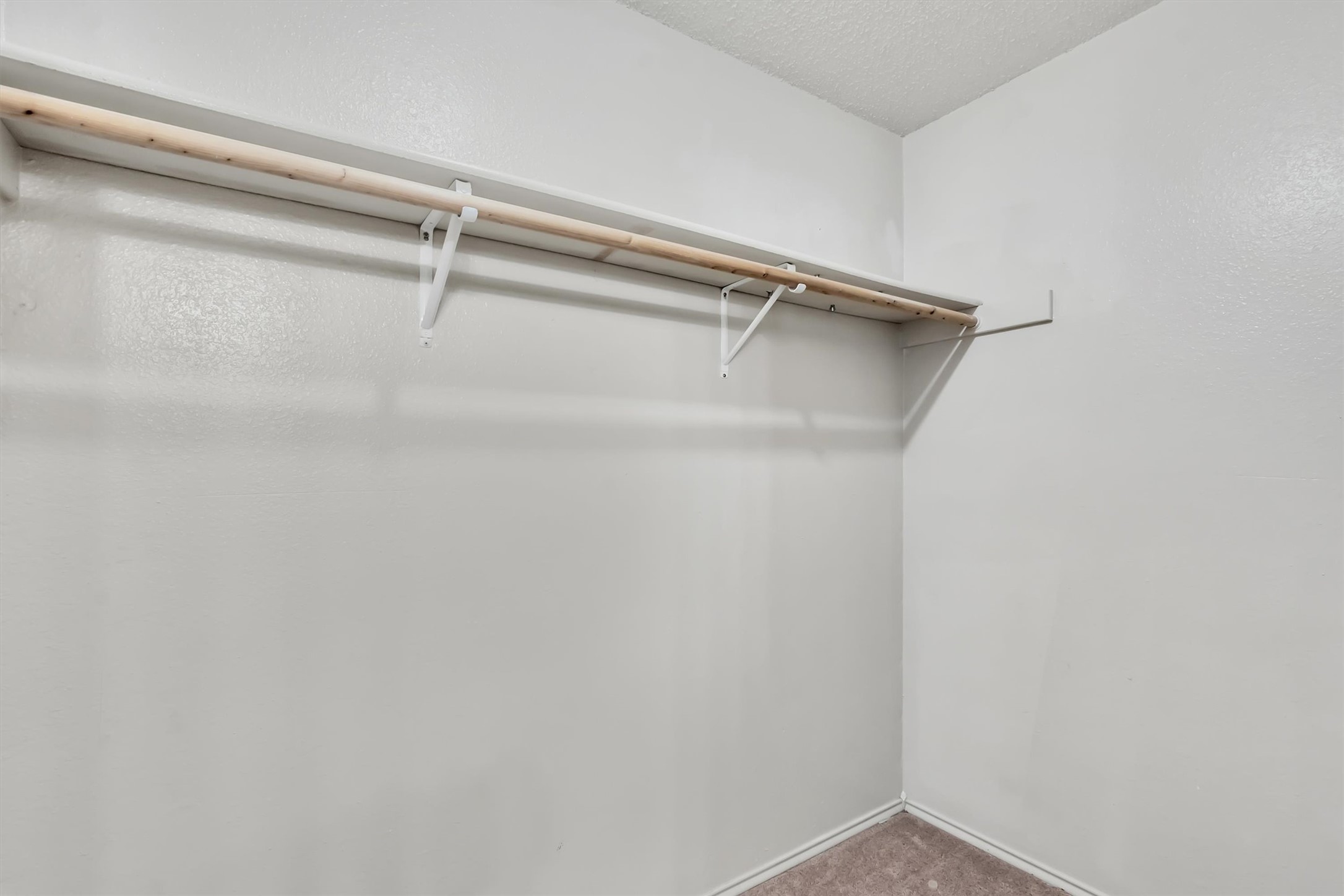 7802 Topawa Cove, Unit B Austin, TX 78729 - Photo 16 of 32 A walk-in closet offers ample storage with convenient shelving and a clothes rod.