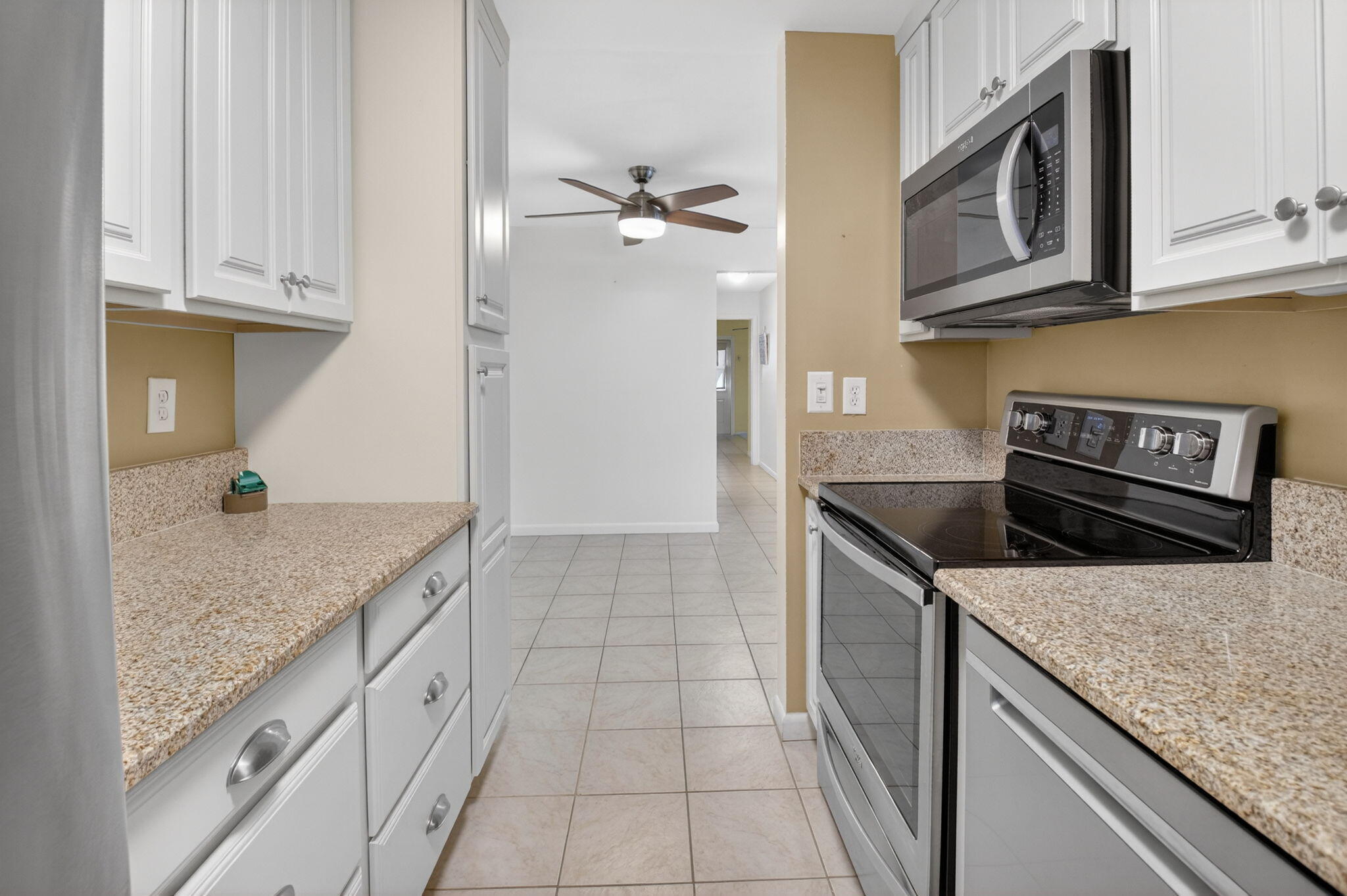270 High Point Court, Unit D Boynton Beach, FL 33435 - Photo 13 of 41 a kitchen with granite countertop a sink stainless steel appliances and cabinets