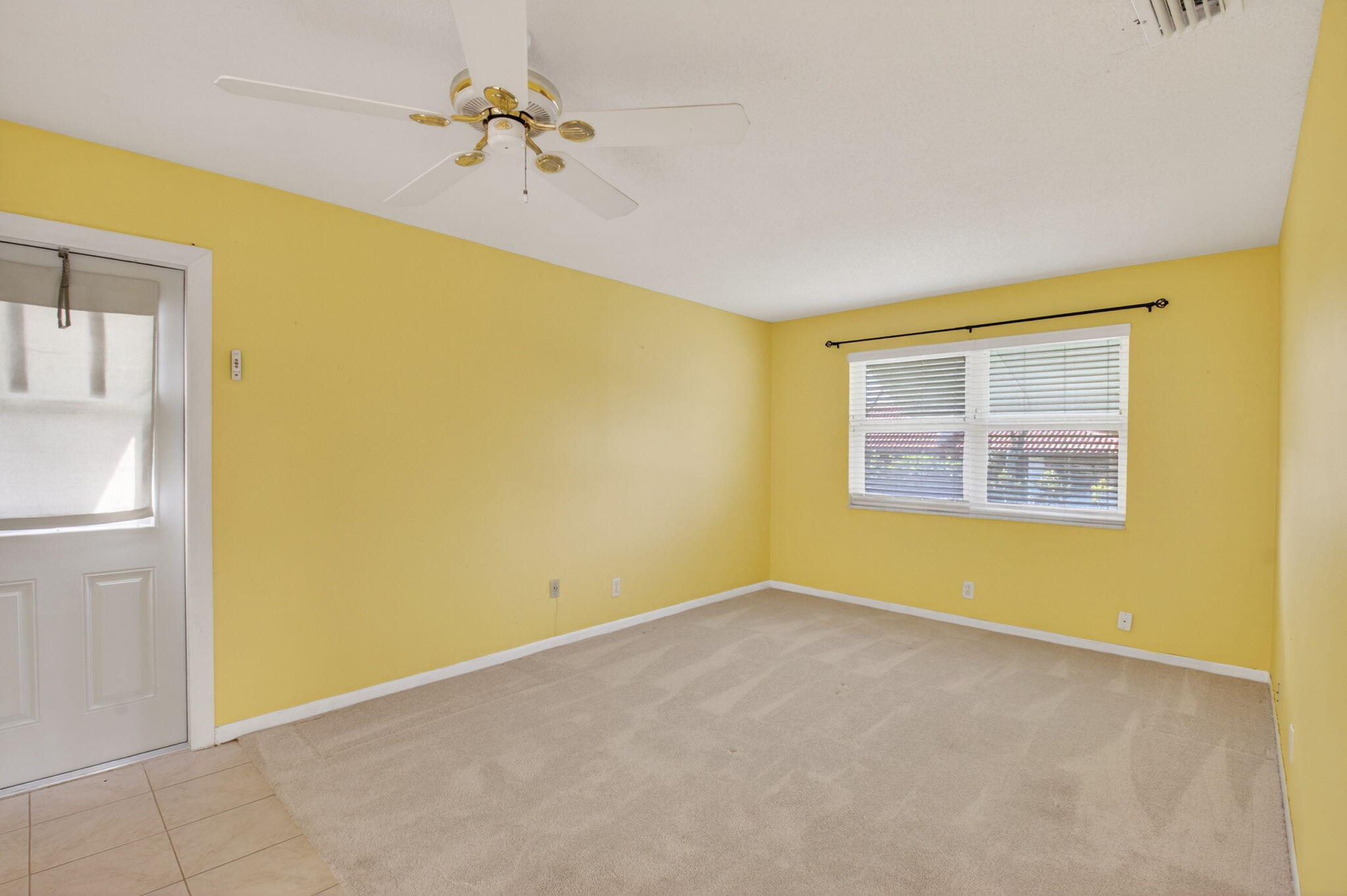 270 High Point Court, Unit D Boynton Beach, FL 33435 - Photo 17 of 41 a view of a big room with windows and chandelier fan