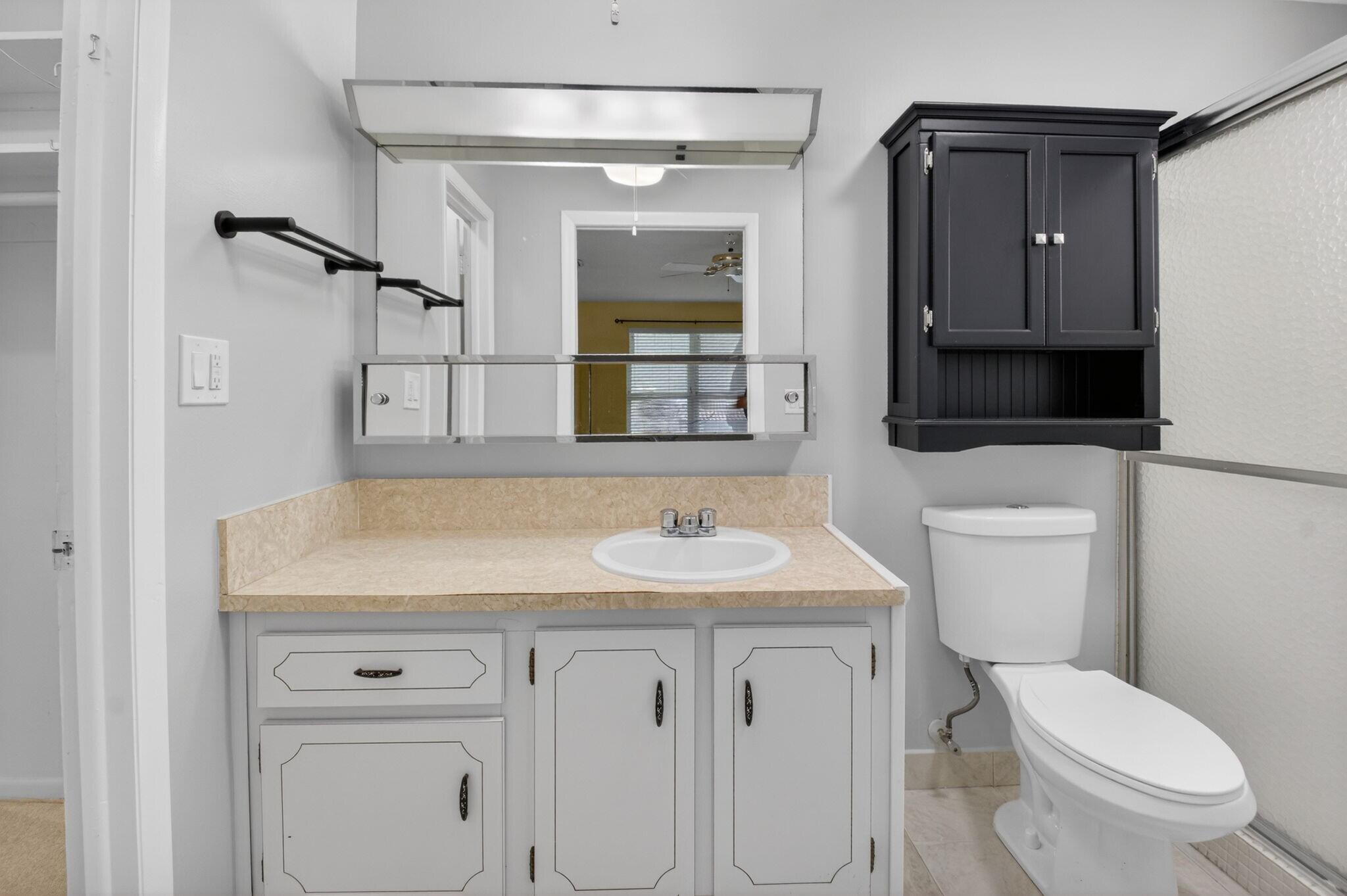 270 High Point Court, Unit D Boynton Beach, FL 33435 - Photo 20 of 41 a bathroom with a sink toilet vanity and mirror