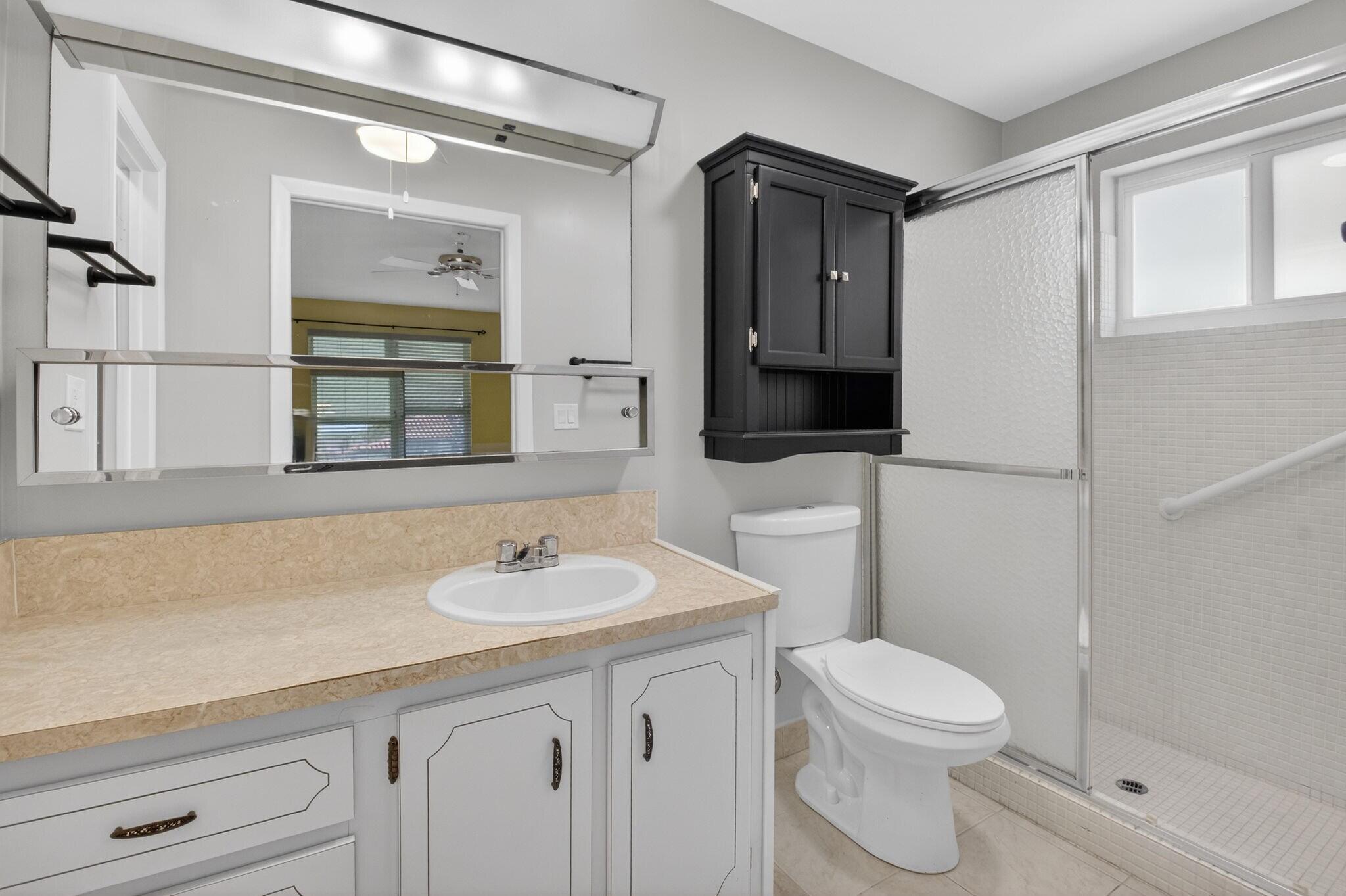 270 High Point Court, Unit D Boynton Beach, FL 33435 - Photo 21 of 41 a bathroom with a sink a toilet and shower