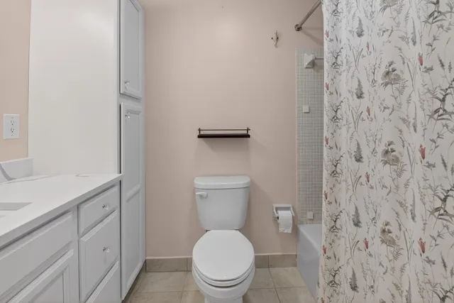 a white toilet sitting next to a bathroom sink