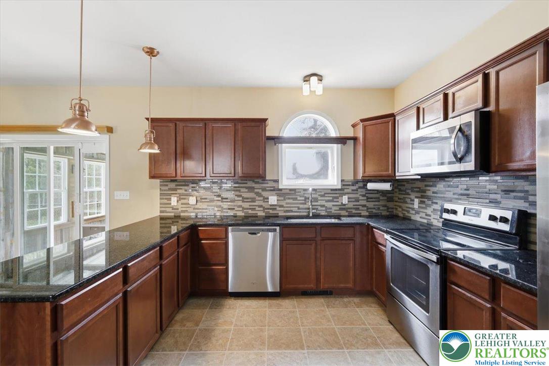 64 Robertson Road Jim Thorpe, PA 18229 - Photo 19 of 54 a kitchen with stainless steel appliances granite countertop a sink and stove top oven