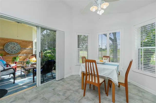 a view of a dining room with furniture a chandelier and wooden floor