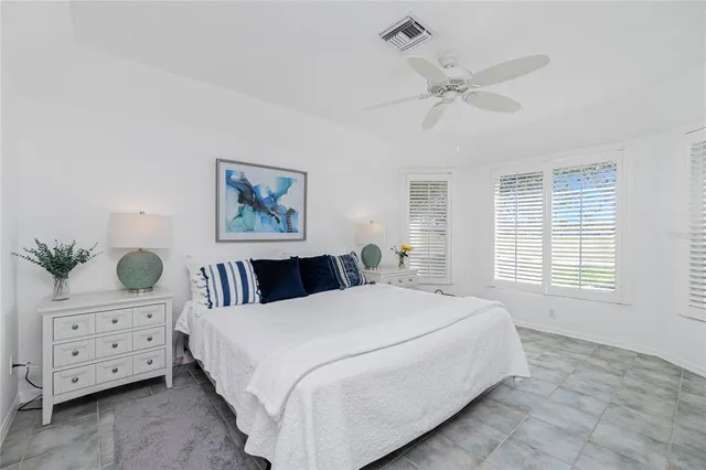 a spacious bedroom with a bed and a window