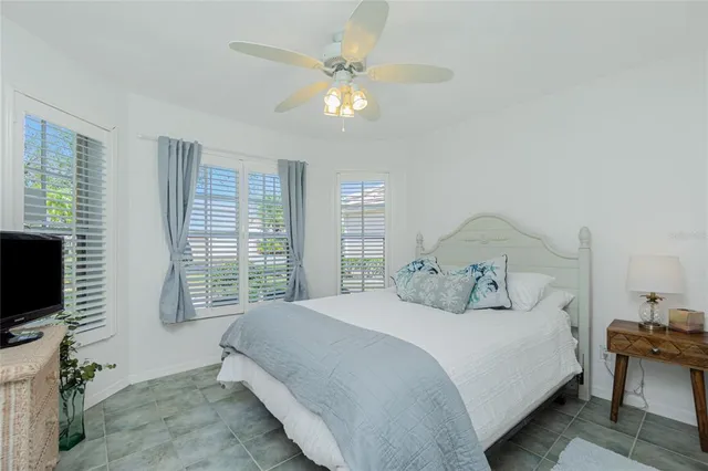 a bedroom with a large bed and a flat tv screen on dresser