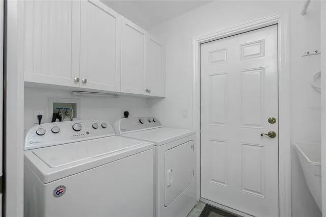 a view of storage and utility room with washer and dryer