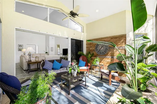 a room with lots of furniture and a potted plant