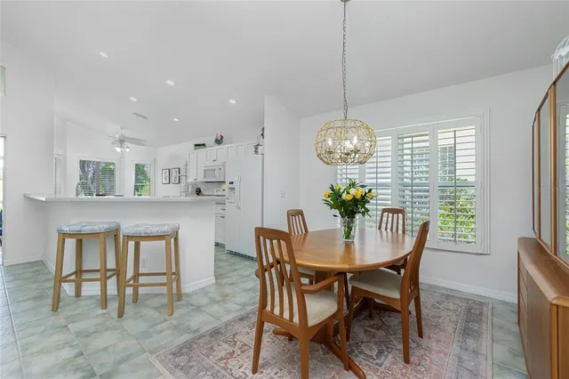a view of a dining room with furniture window and outside view