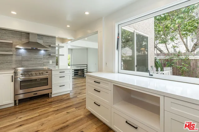 a kitchen with granite countertop a stove and a refrigerator