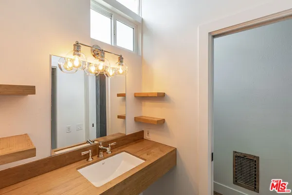 a bathroom with a sink a mirror and a toilet