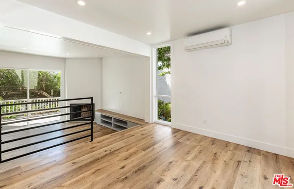 a view of a room with wooden floor and windows