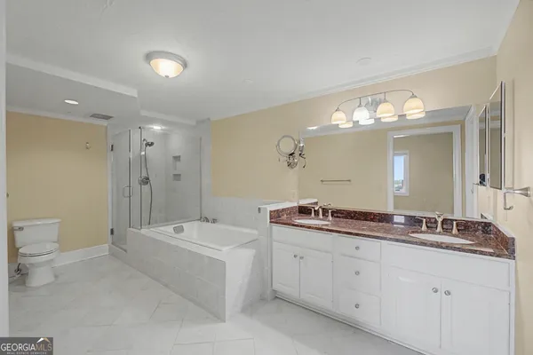 an empty room with wooden floor and a ceiling fan