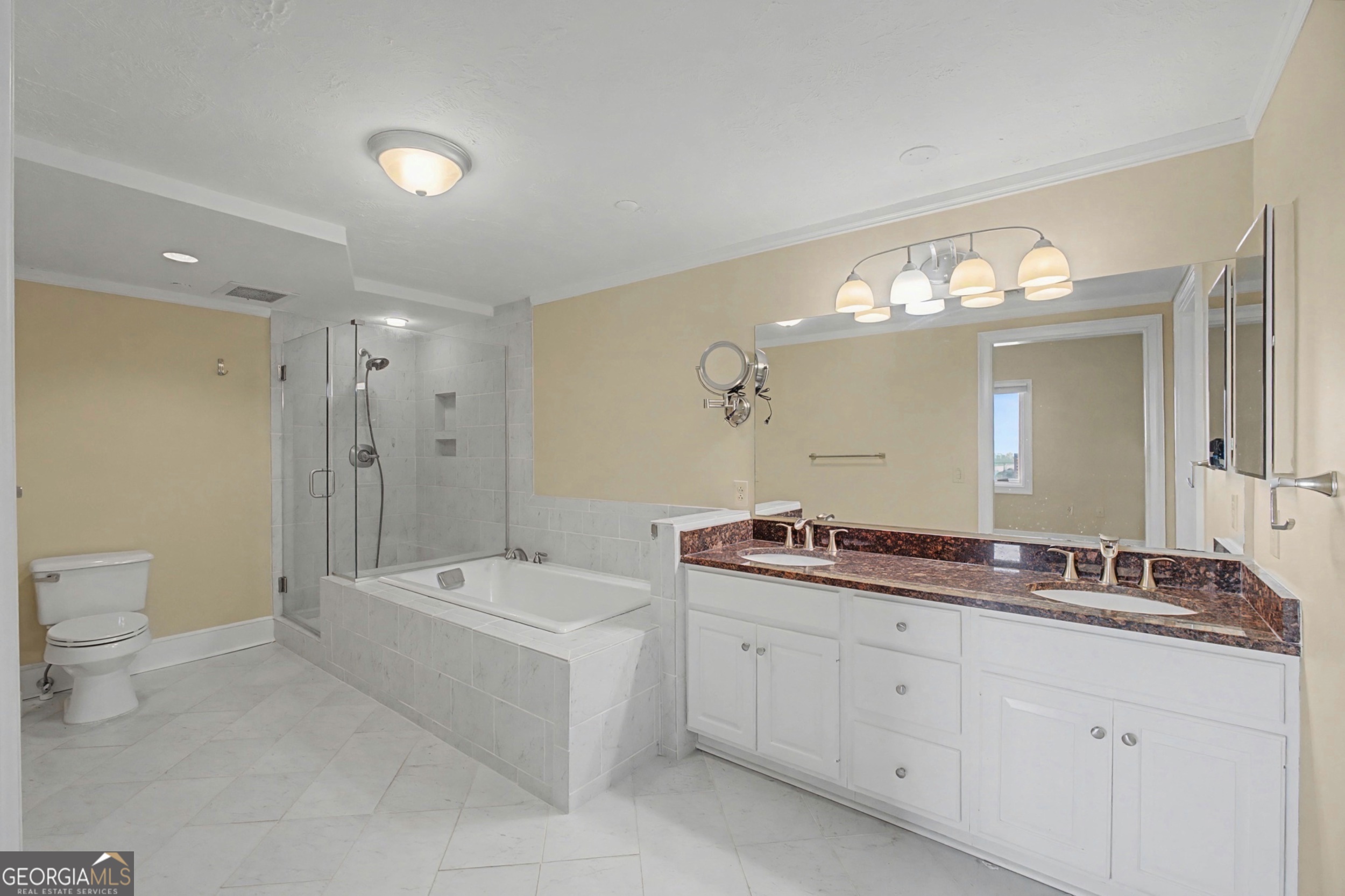 1 7th Street, Unit 1402 Augusta, GA 30901 - Photo 24 of 38 a bathroom with a double vanity sink a toilet a mirror and shower