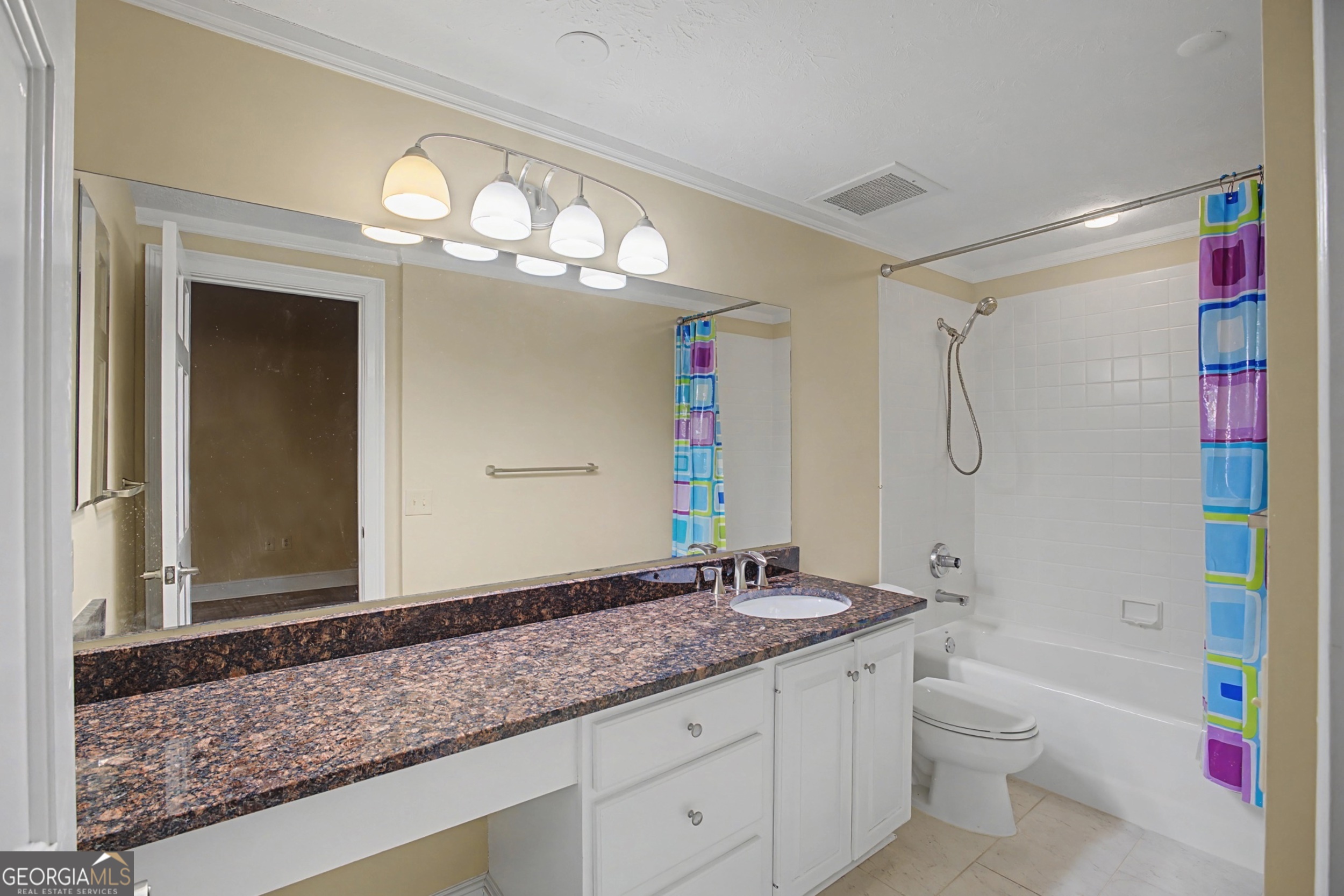 1 7th Street, Unit 1402 Augusta, GA 30901 - Photo 27 of 38 a bathroom with a granite countertop sink a toilet and a shower