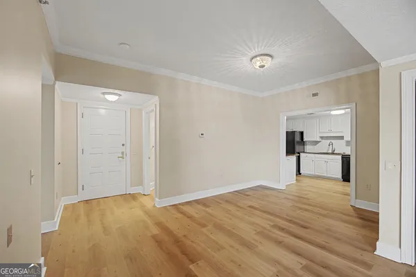 a kitchen with granite countertop a stove sink and refrigerator