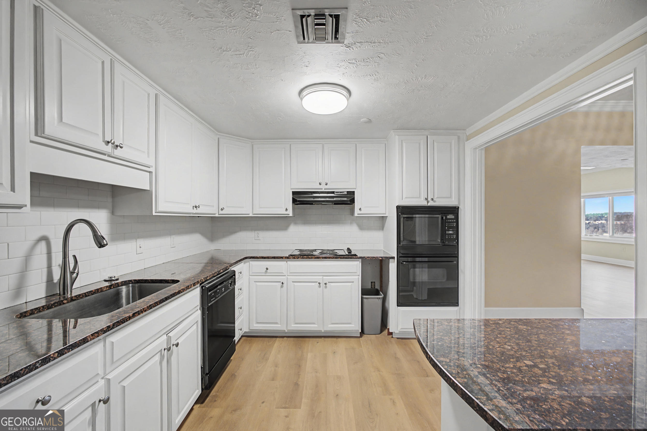 1 7th Street, Unit 1402 Augusta, GA 30901 - Photo 9 of 38 a kitchen with stainless steel appliances granite countertop a refrigerator sink and cabinets