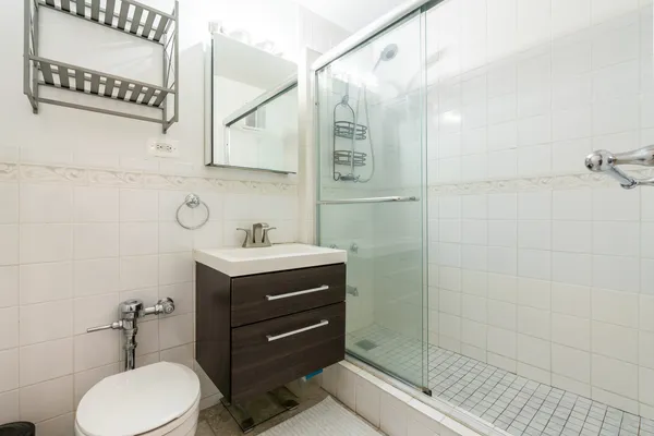 a bathroom with a sink vanity mirror and toilet
