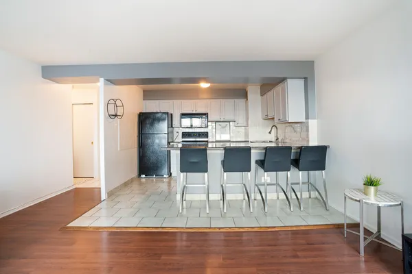 a view of a dining room with furniture and wooden floor
