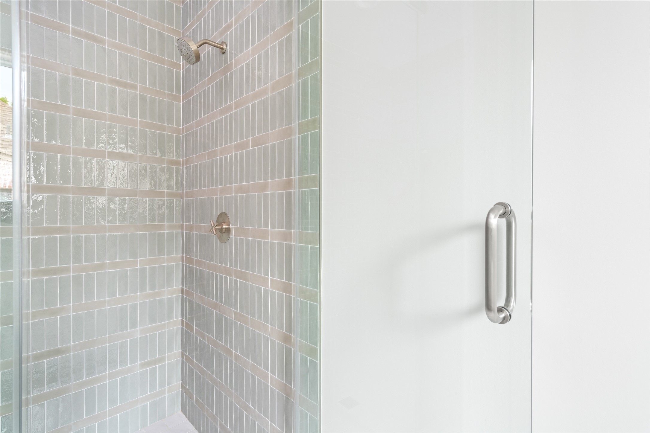 4006 Overbrook Lane Houston, TX 77027 - Photo 40 of 50 Secondary ensuite bath featuring a walk-in shower with layered tile detailing and subtle tonal variation.